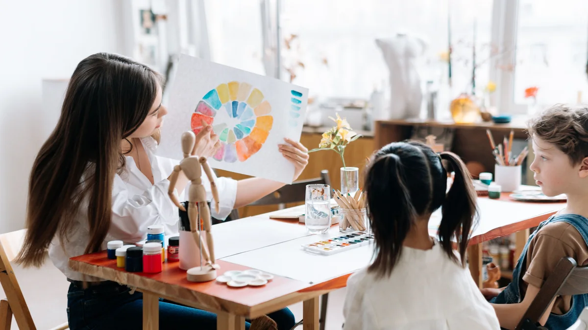 Personnes réunies en atelier de formation créative autour d'une table - illustration de l'article Comment devenir thérapeute holistique en 2026